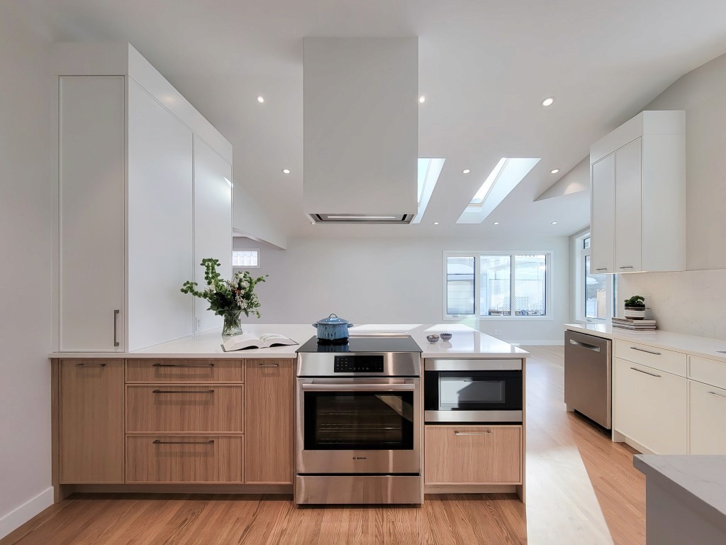 Image of Modern kitchen interior design by KHD Homes featuring wooden cabinets and sleek stainless steel appliances layout.