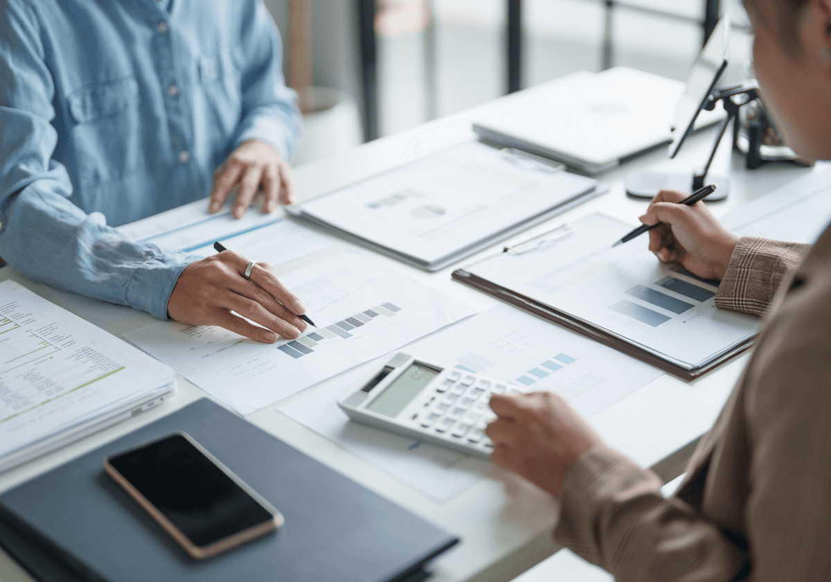 Aerial view of a winding road surrounded by dense green and yellow trees, showcasing nature’s vibrant colors.