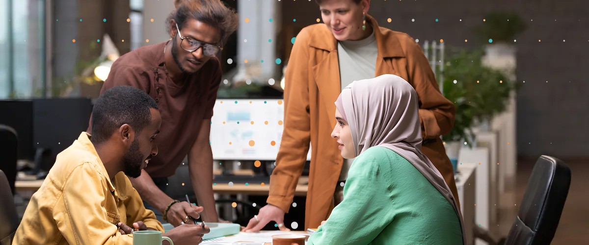 people standing and sitting in a meeting