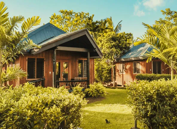 Garden Bures with blue roofs and timber structure at Uprising Beach Resort Fiji
