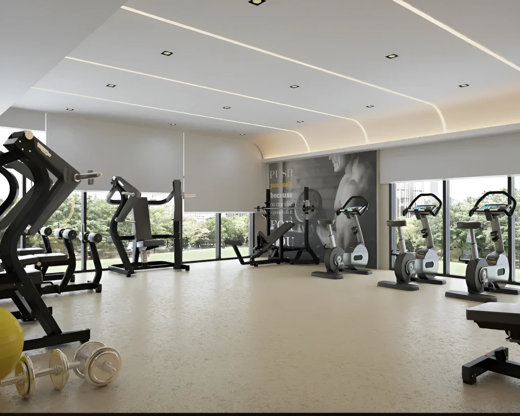 Gym space in Azizi Central, Dubai, equipped with workout machines and surrounded by mirrors for fitness activities.