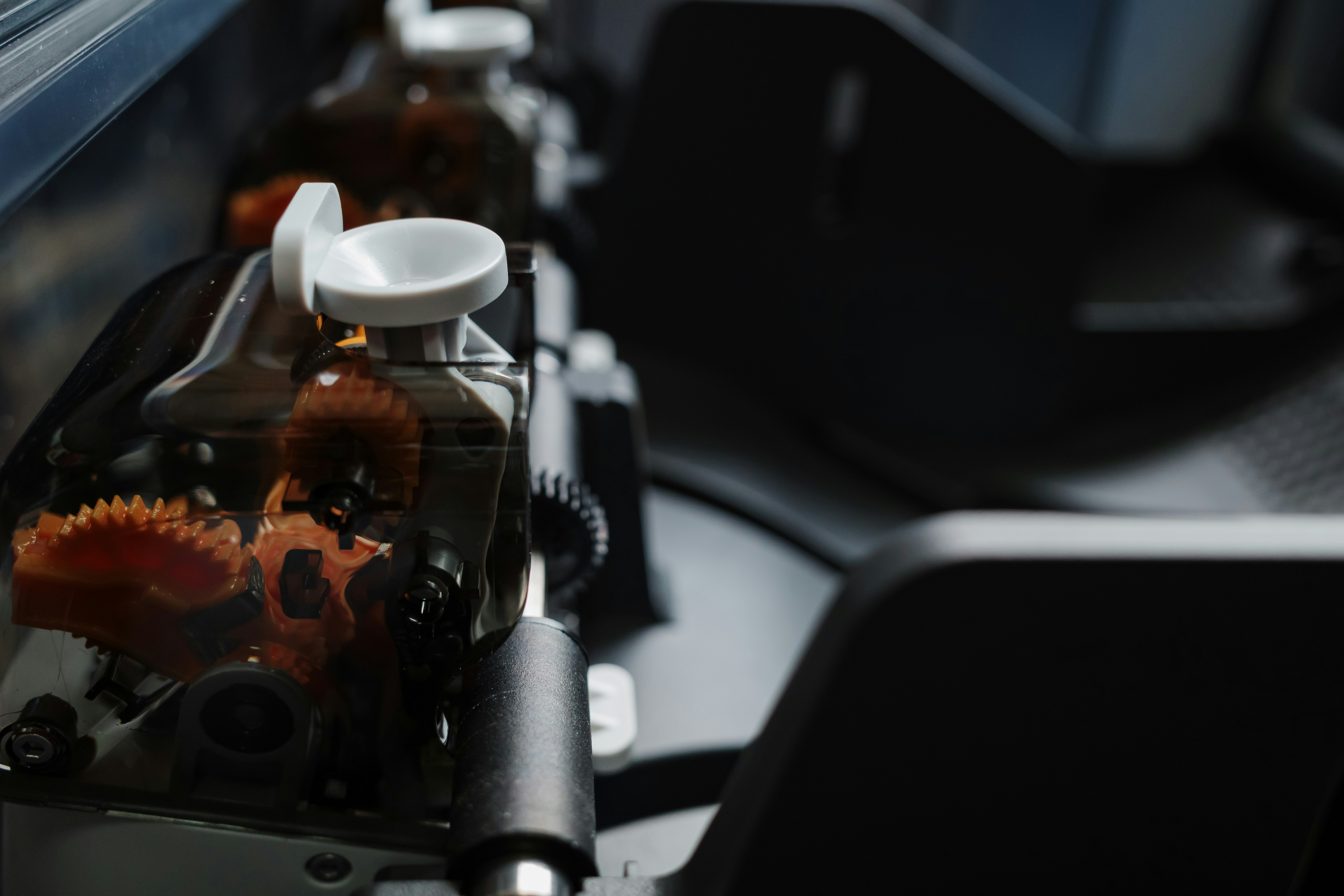 Transparent multi-material feeder system showing internal gears and filament movement