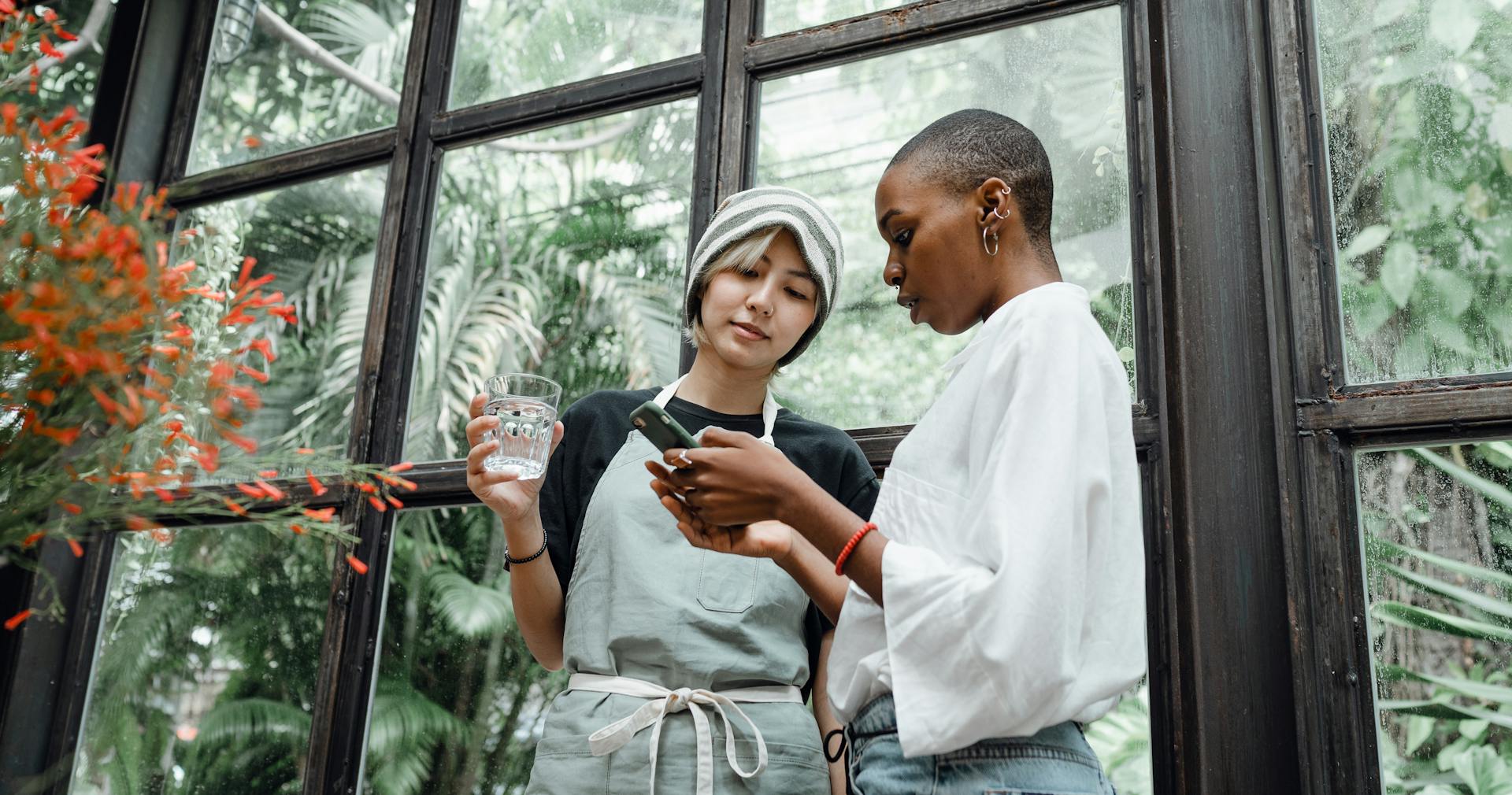 2 women checking their mobile phone