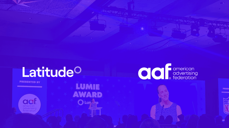 atitude and American Advertising Federation (AAF) logos overlaid on a photo of the AAF Lumie Awards stage, where a speaker stands at a podium before a seated audience, bathed in blue lighting