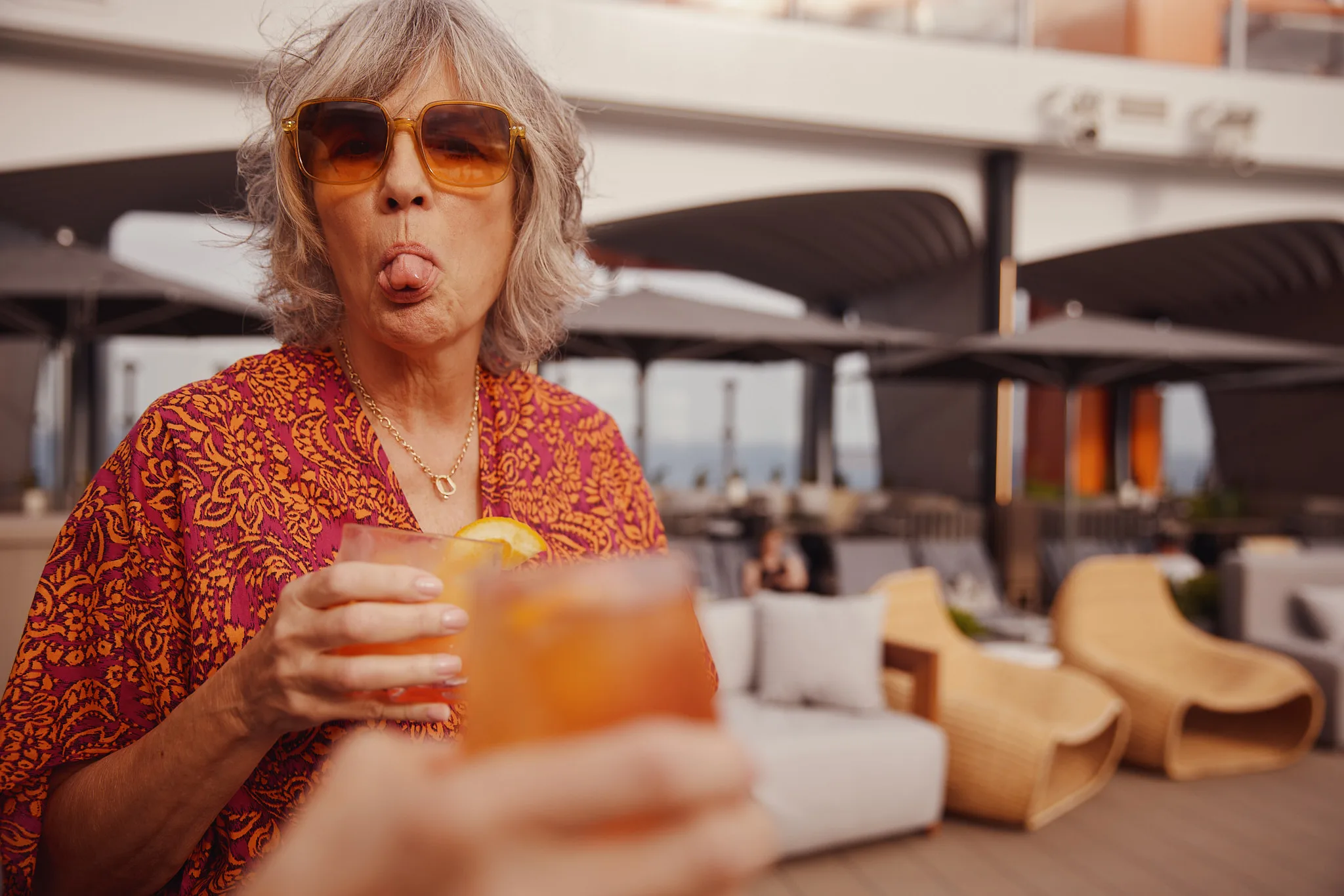 woman sticking out tongue during rooftop toast — lifestyle photography by Tom Kubik