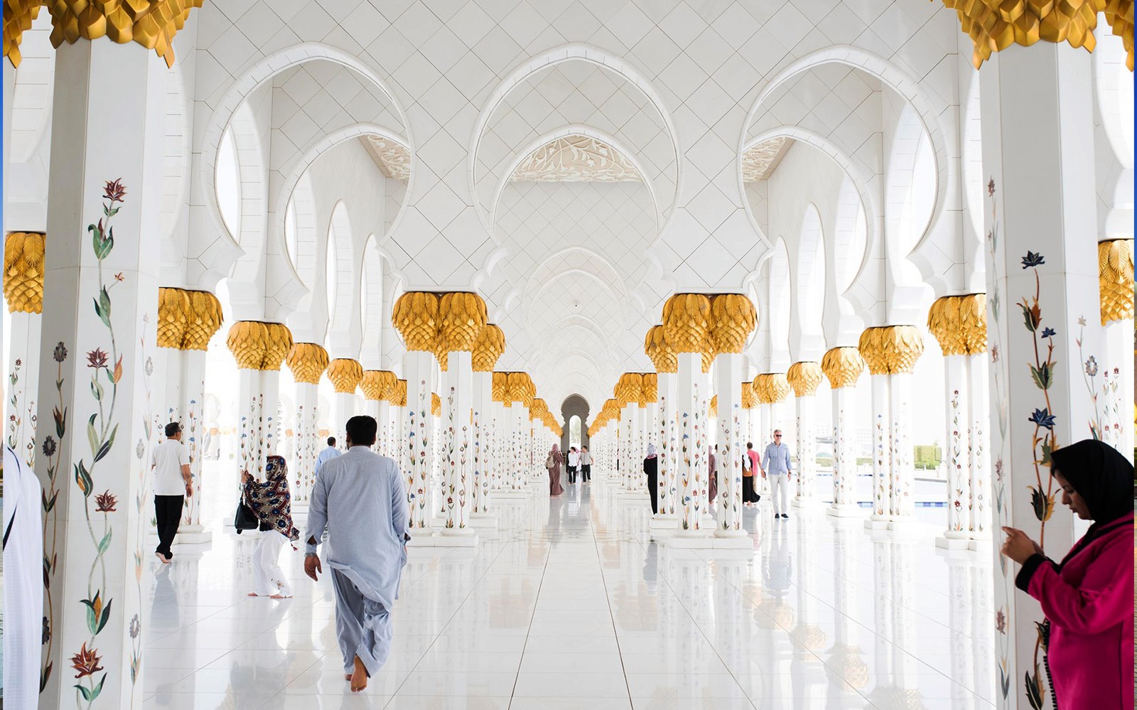 Abu Dhabi Mosque interior with ornate columns during guided tour from Dubai.