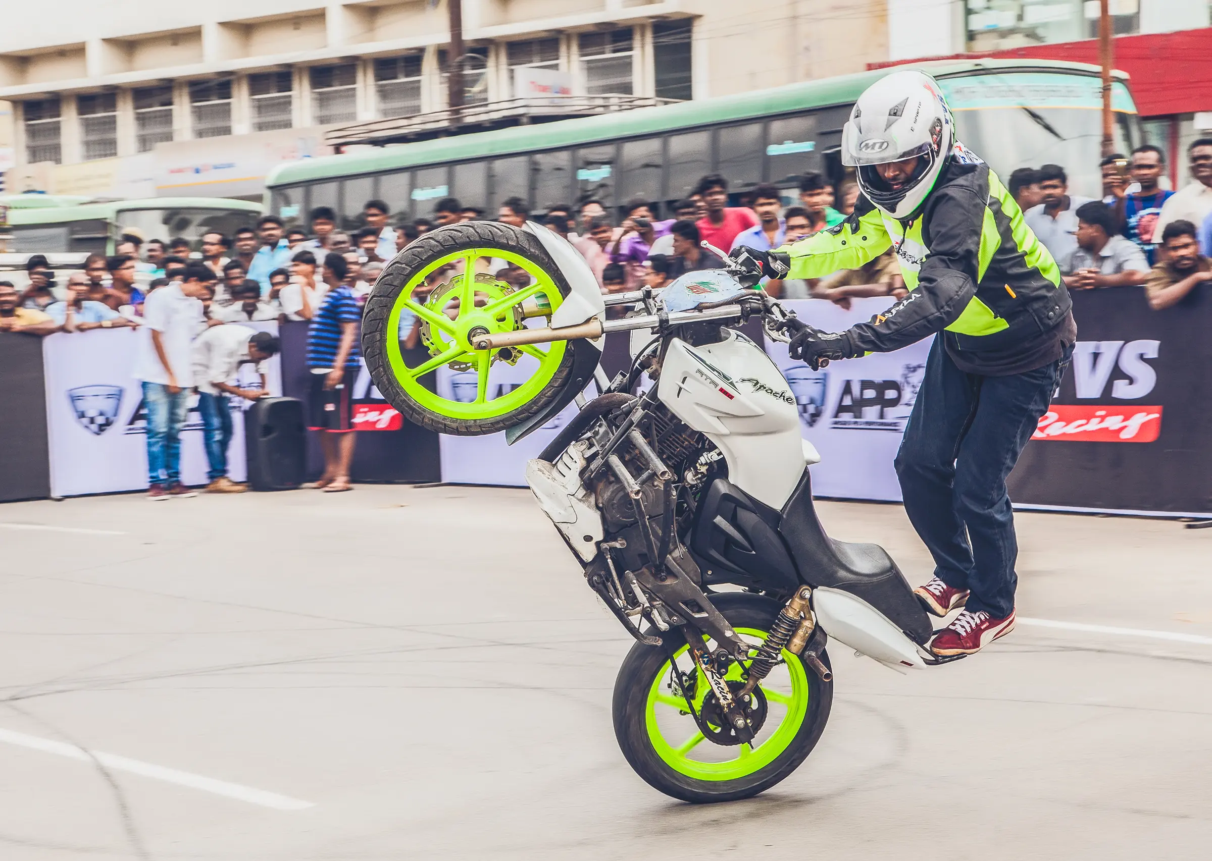 Man does wheelie at TVS event shoot, captured on tape cassette during road stunt performance