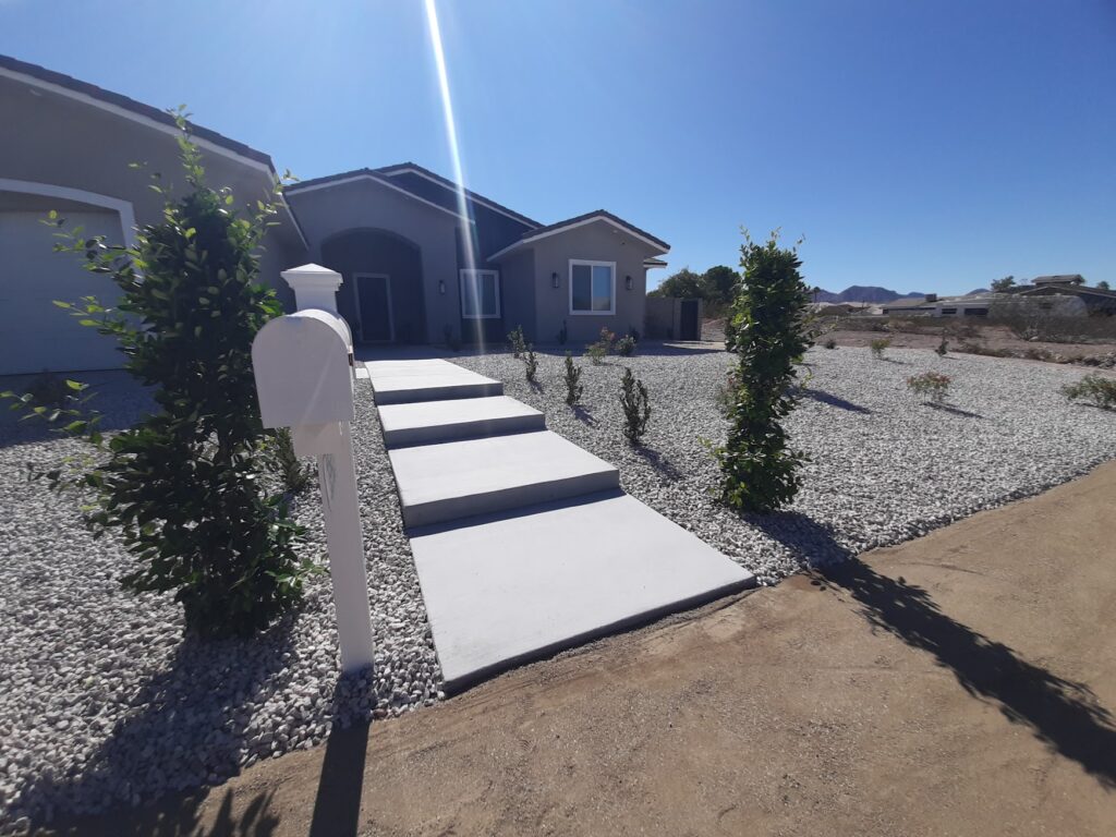 FreshStart Landscaping Vegas desert front yard with concrete walkway rock ground cover and plants
