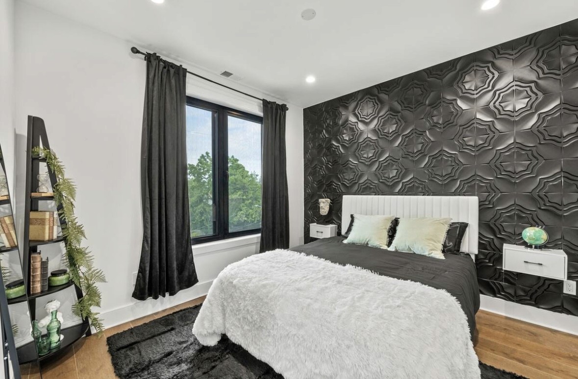 Serene cave bedroom with canyon view and ferns.