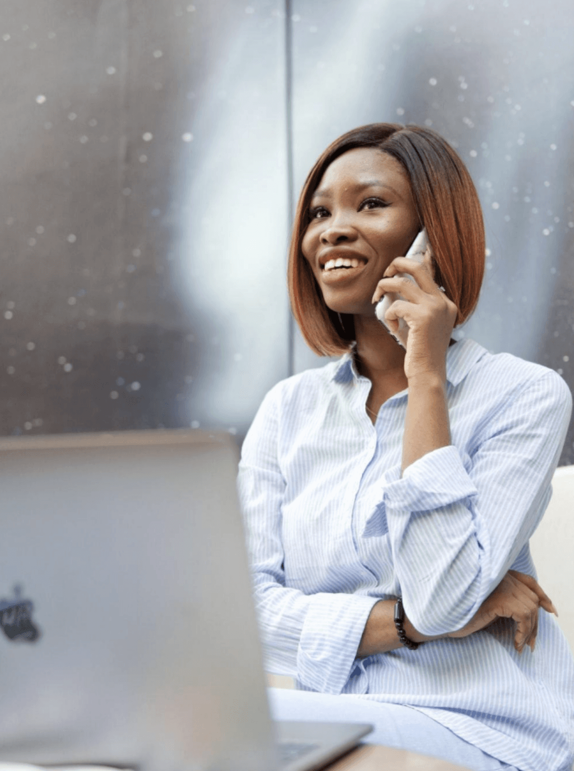 woman holding a phone and man looking at the phone. both are smiling