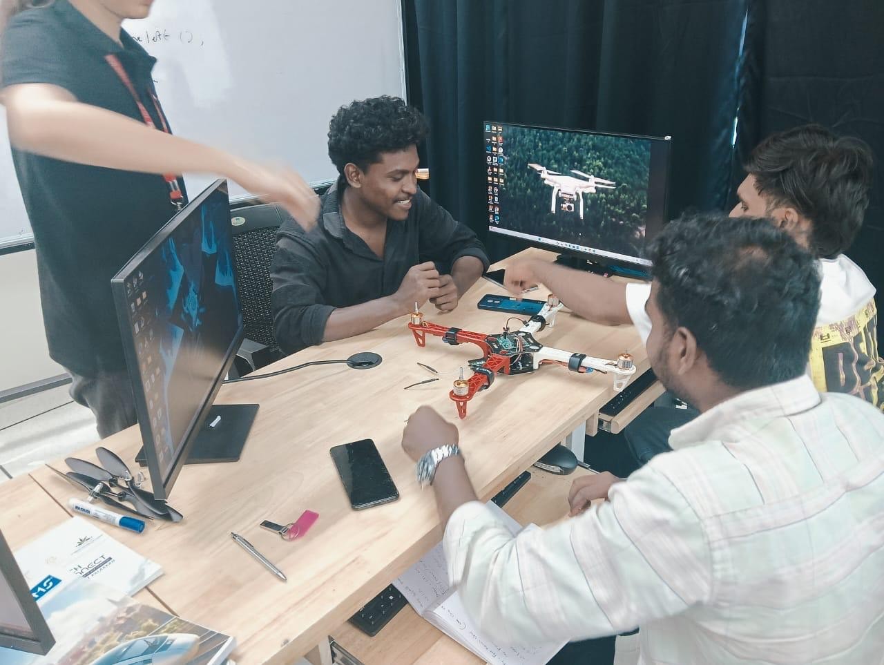 Team assembling a quadcopter drone