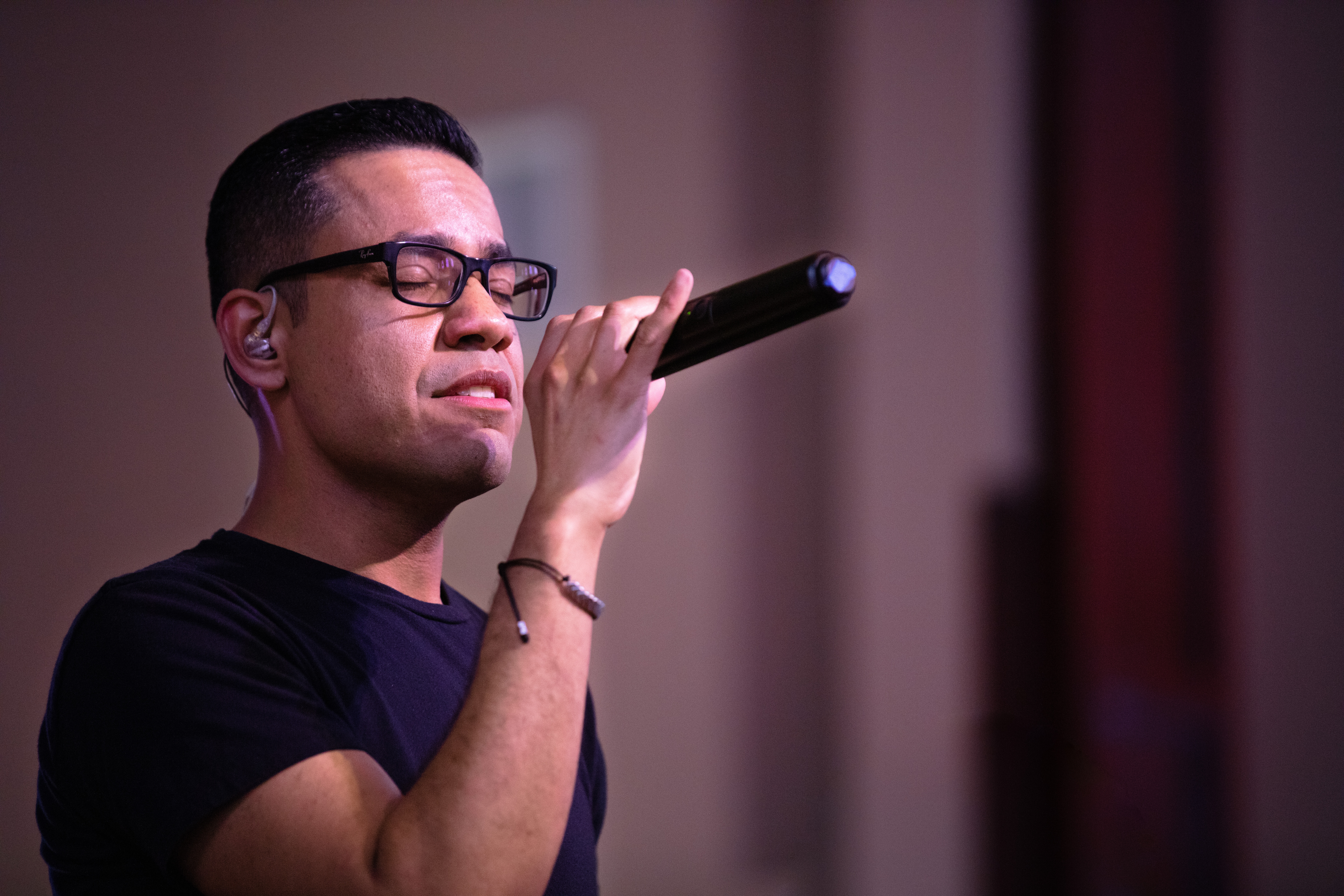 man singing with a mic in his hand - ai vocalist