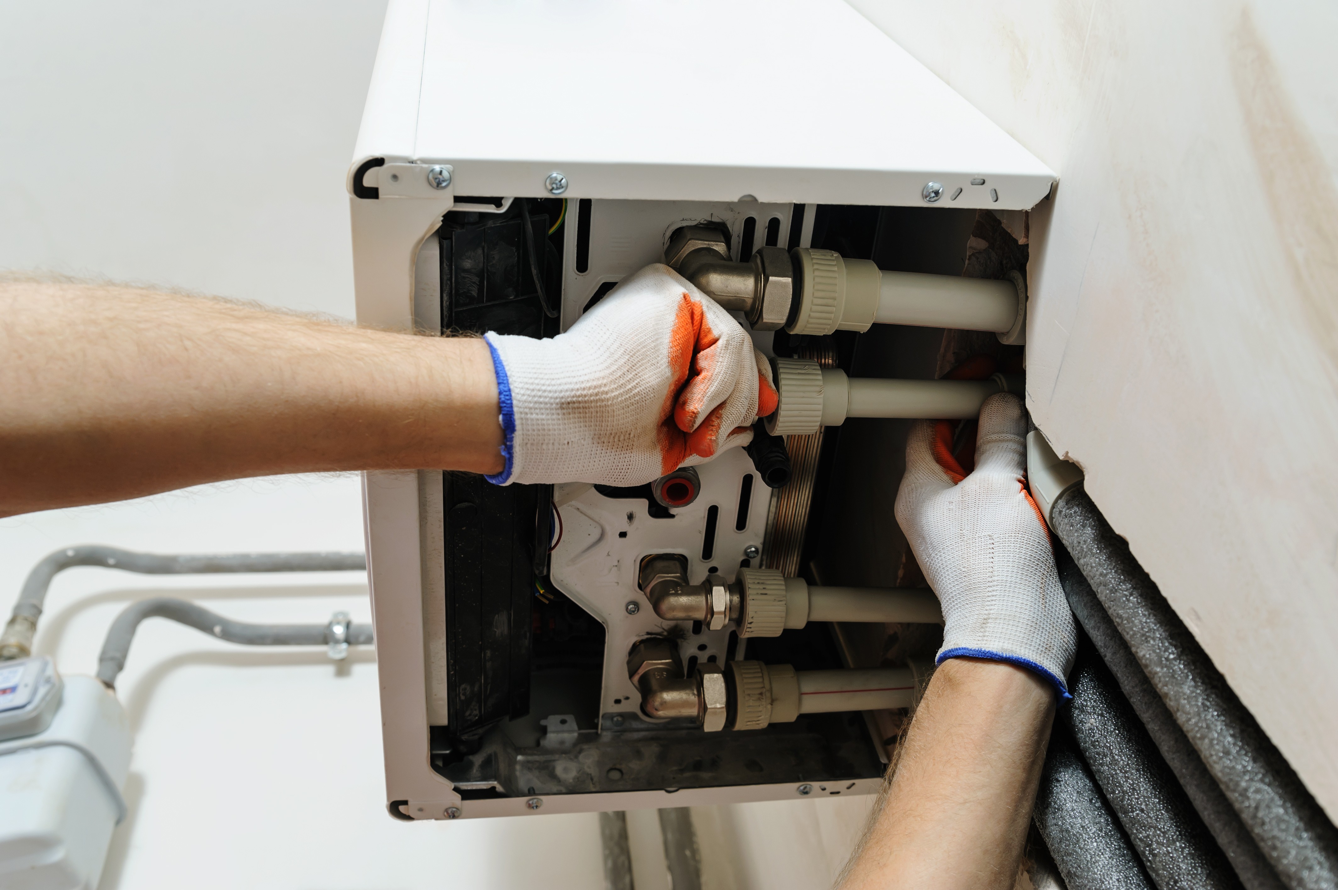 An engineer inspecting an air conditioning unit