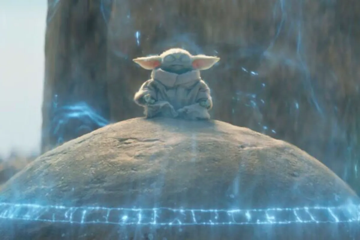 Grogu sits cross-legged atop the ancient Seeing Stone on Tython, his eyes closed in deep meditation. A glowing blue energy field surrounds him, channeling the Force as he reaches out to any Jedi who may be listening across the galaxy.