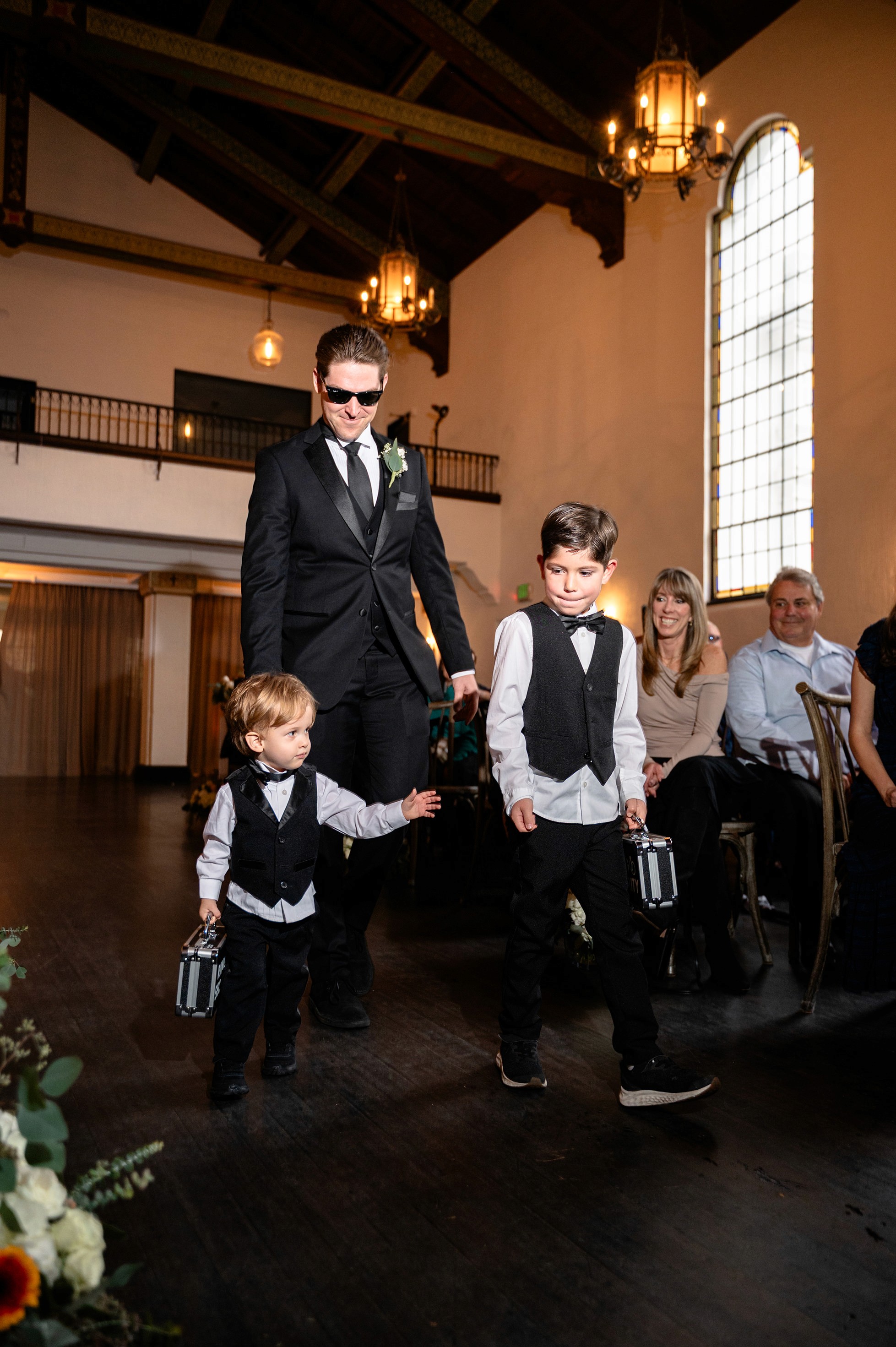 Flat lay wedding details with bouquet, rings, and sparkling bridal heels