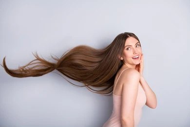 Woman with long brown hair flowing
