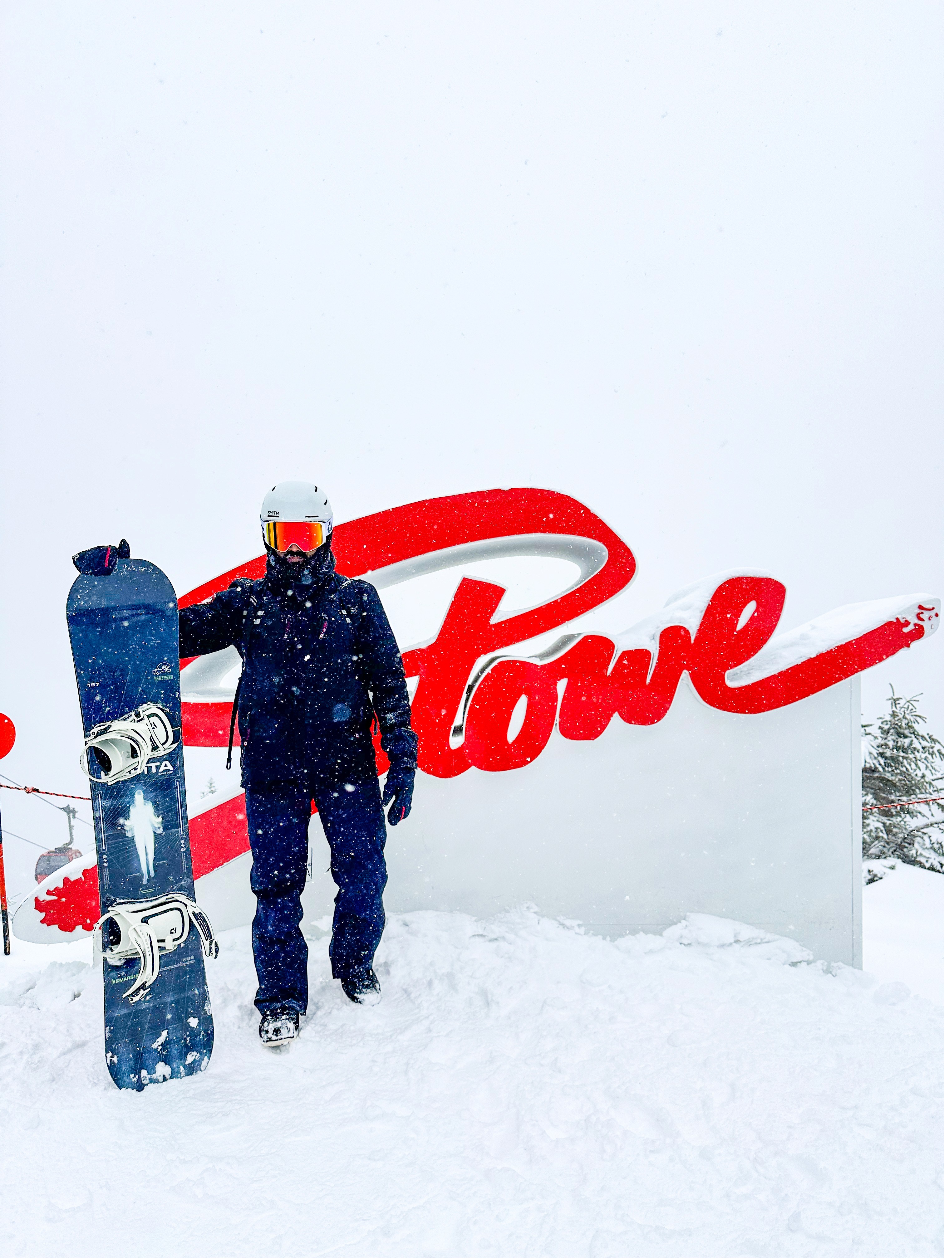 A close-up of a hand wearing multiple decorative rings against a blue background.