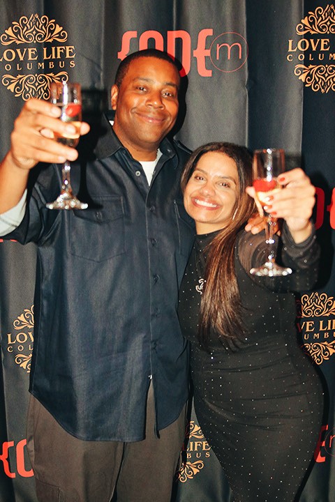 Bartender pouring champagne into a glass, golden liquid catching the backlight
