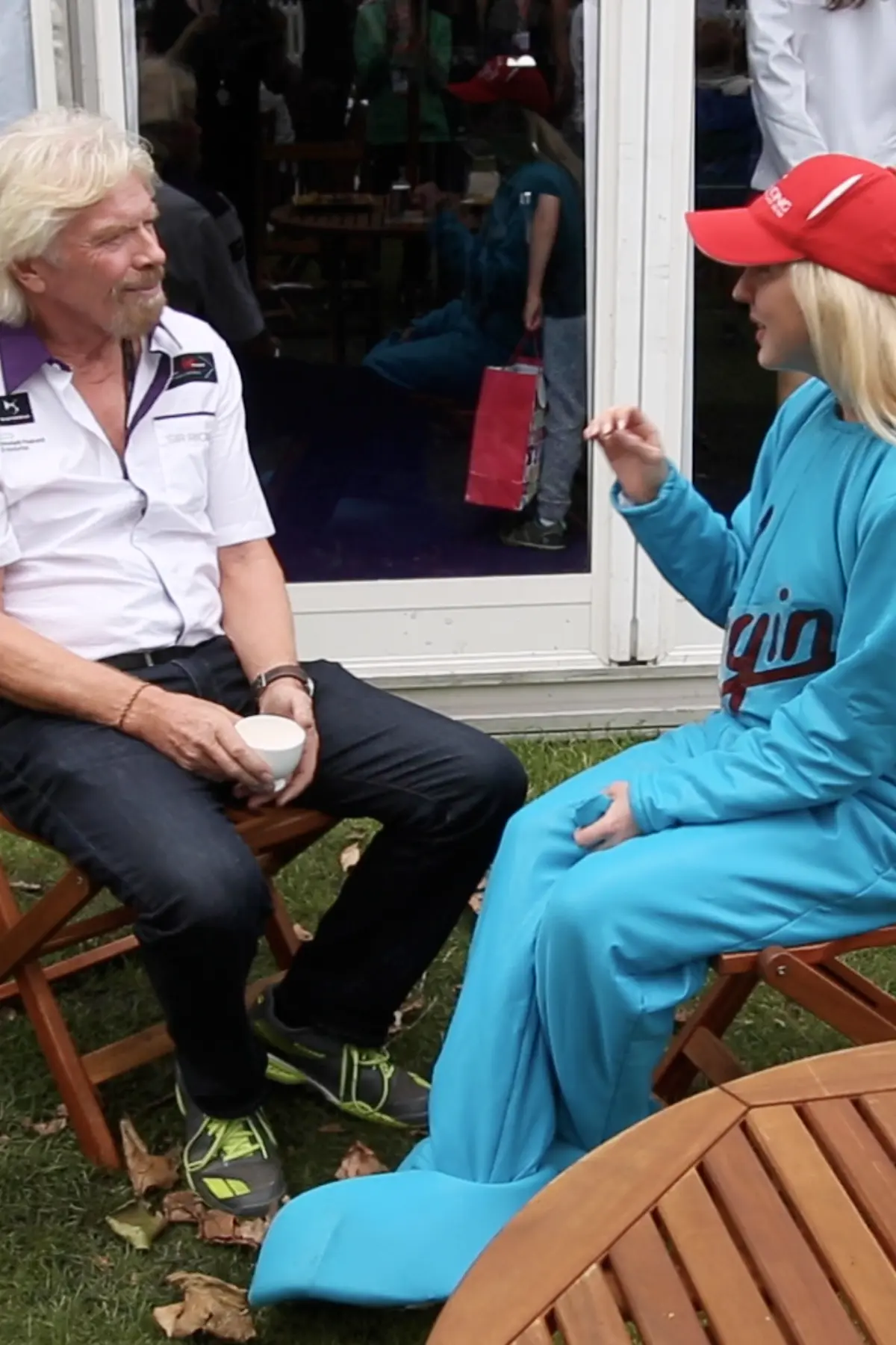 Agent Blonde in a Virgin alien costume speaking with Richard Branson during the interview