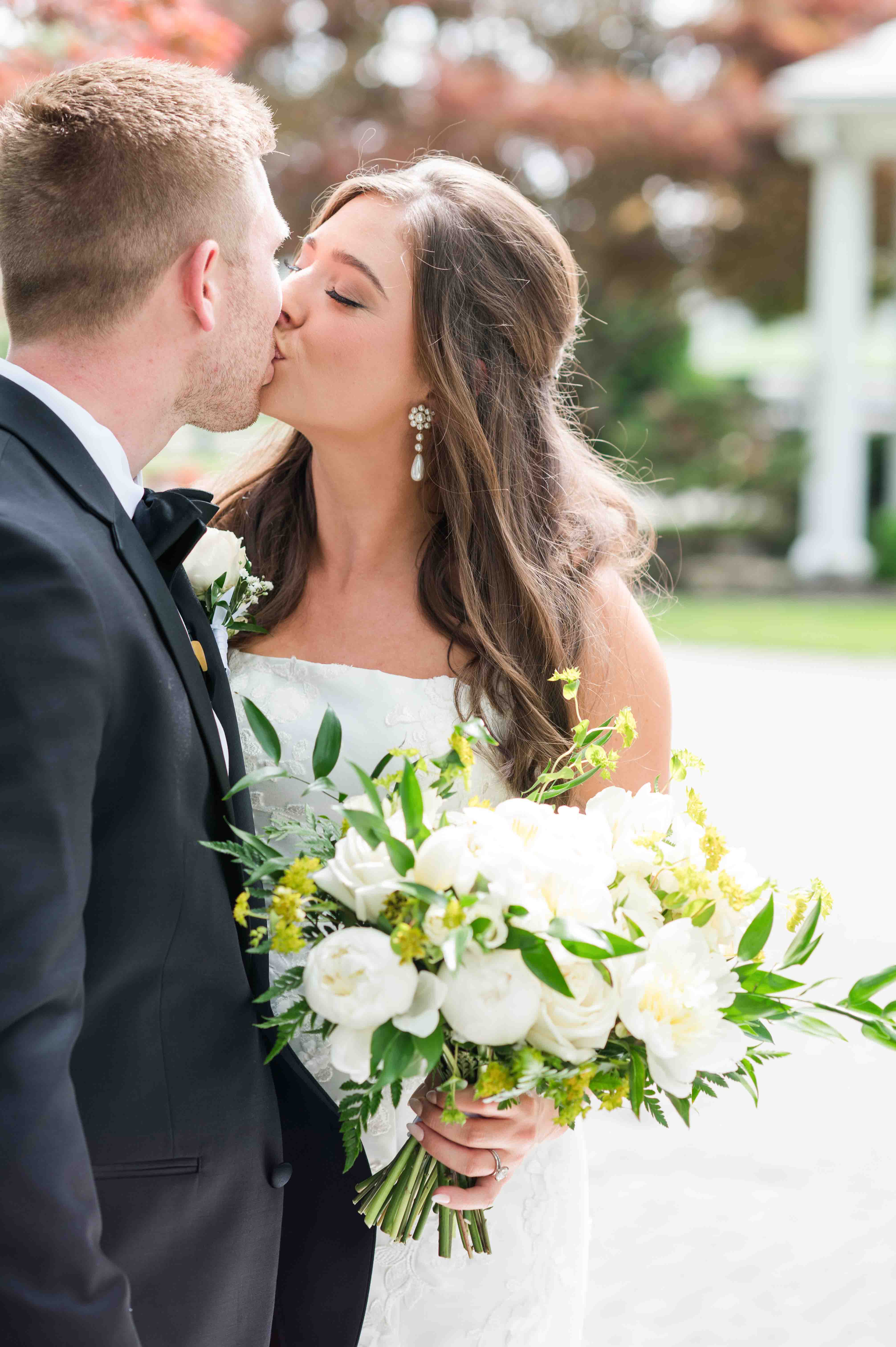 Portrait of bride and groom sharing a kiss on their wedding day.