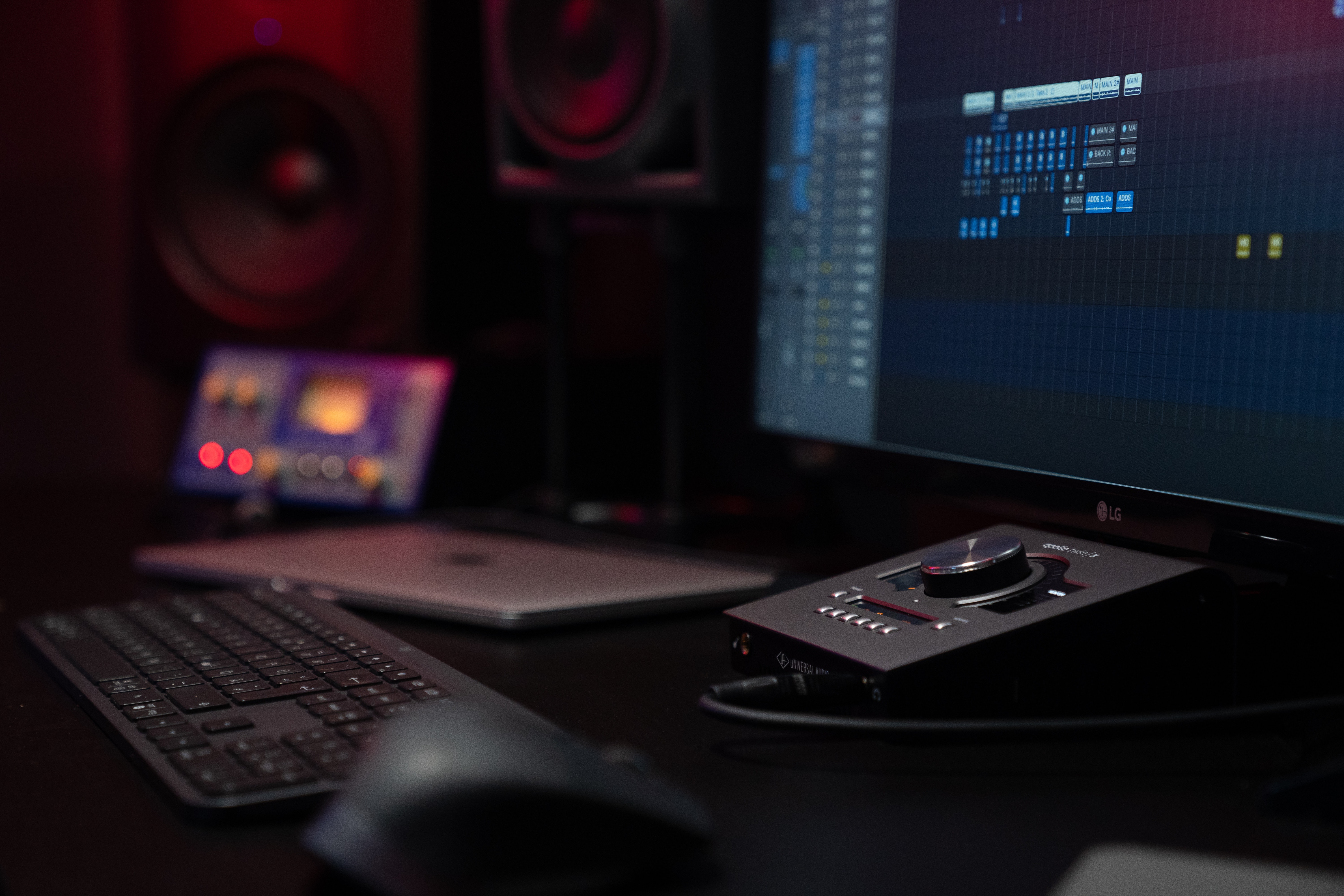 a singer's setup of laptop and computer with ai music tools