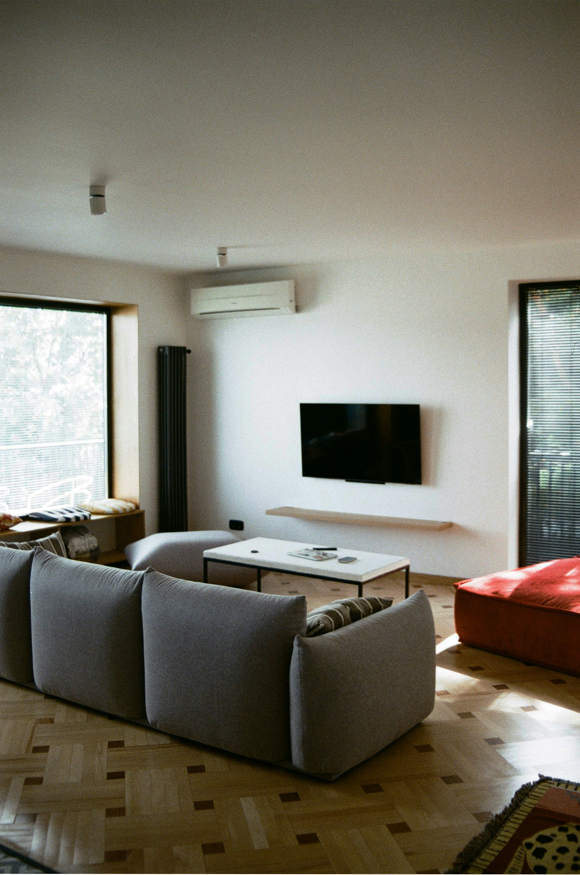 a living room filled with furniture and a flat screen tv