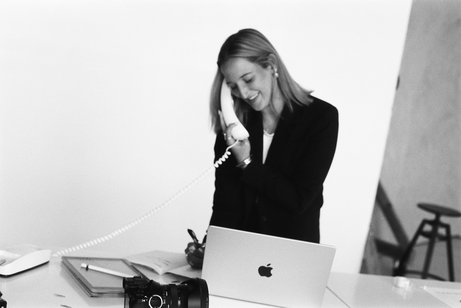 A close-up of a person wearing green-tinted glasses, with a serious expression and smooth skin.