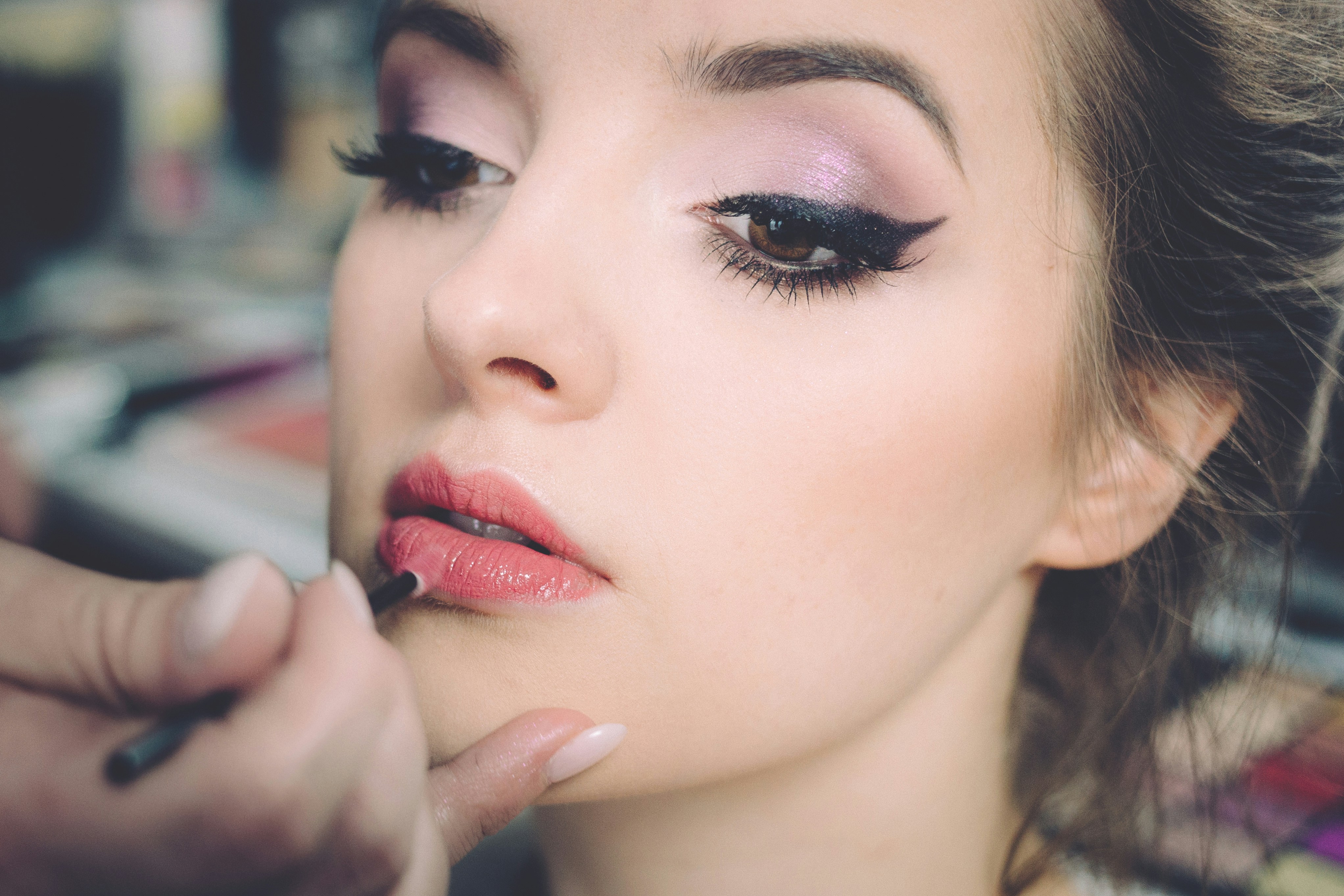 woman applying makeup for Glow Up