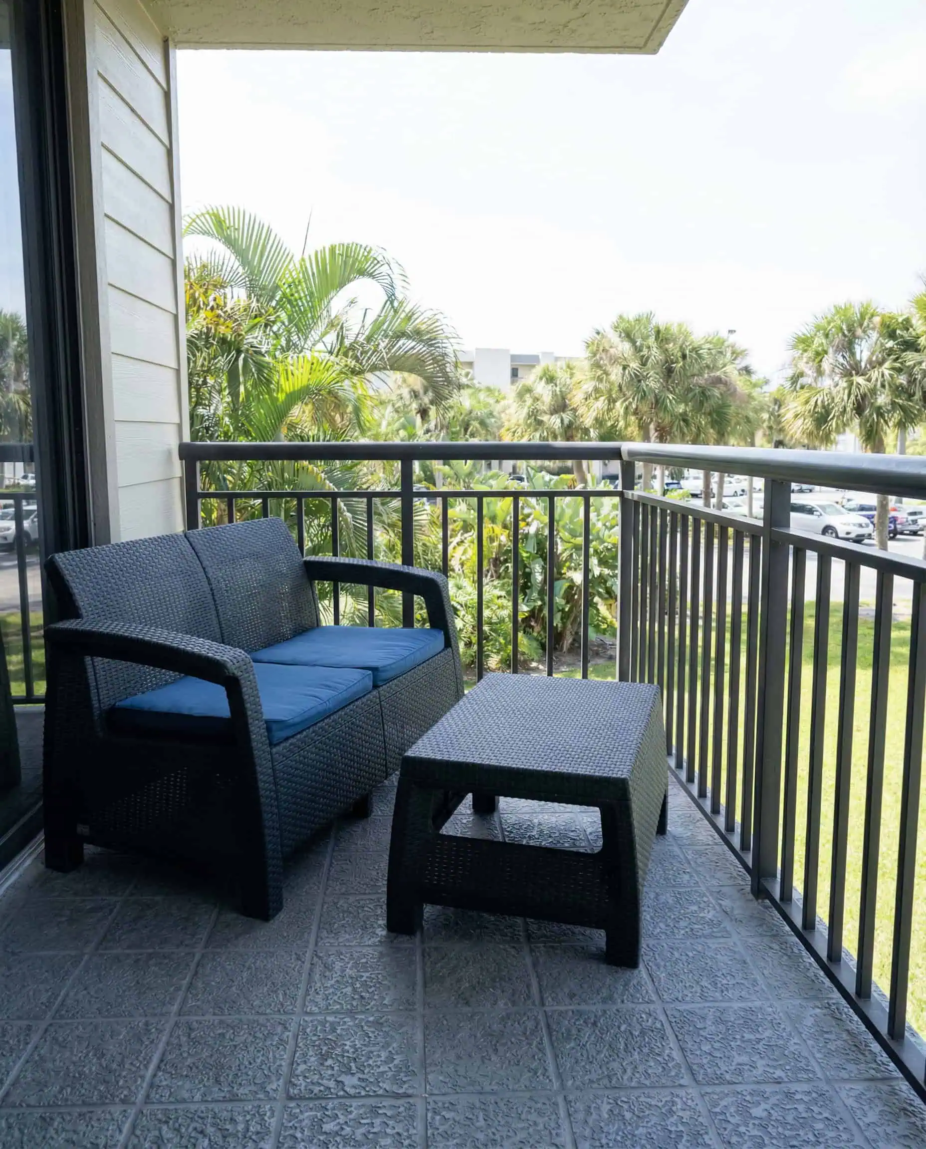Quiet coastal vacation rental balcony with comfortable seating designed for relaxation and unwinding