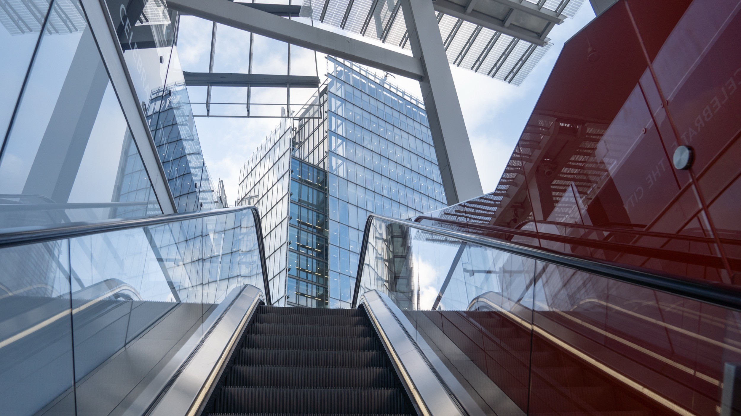 Two classic volkswagen beetles, one green, one cream.