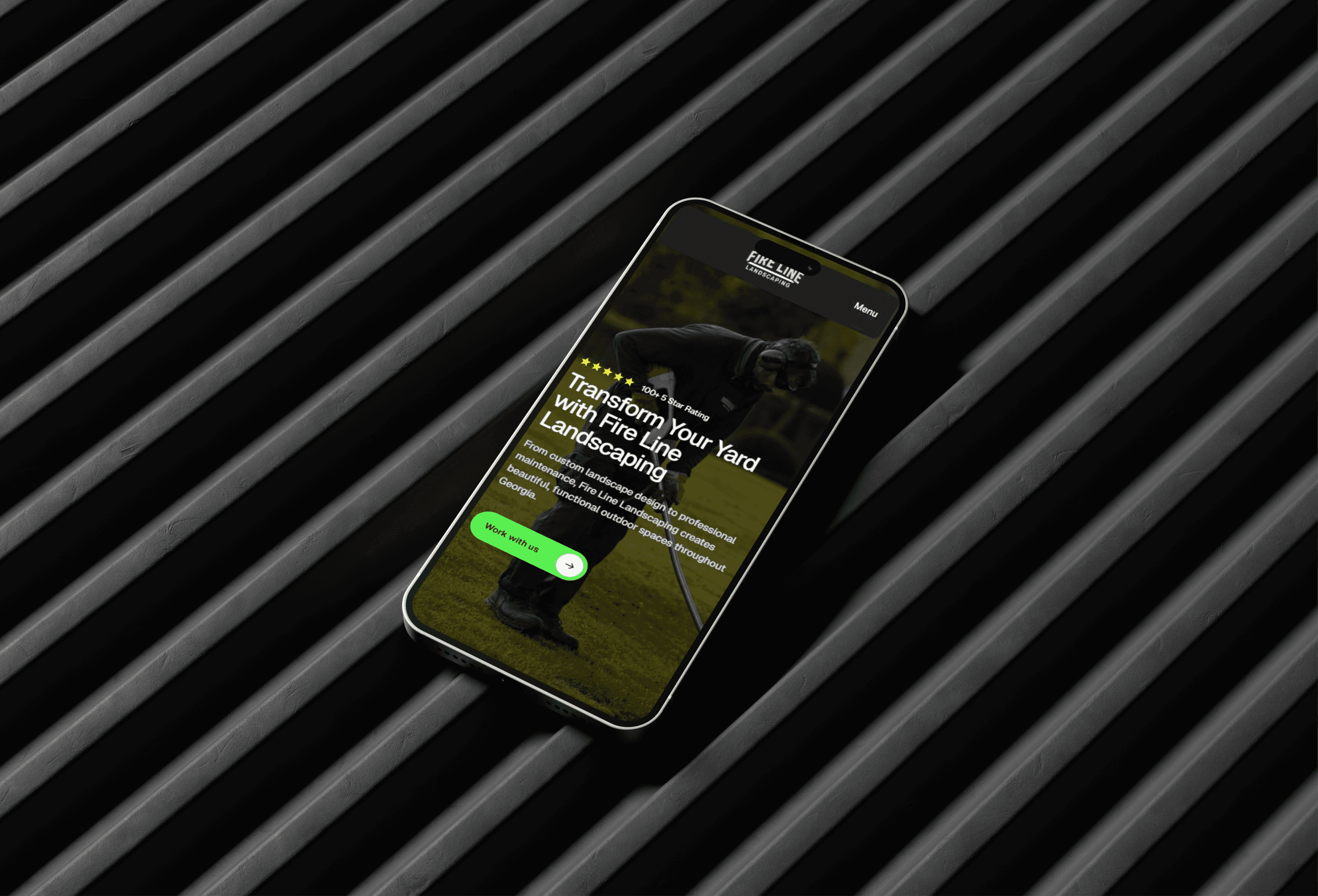 Fire Line Landscaping website displayed on smartphone – landscaping and lawn care services