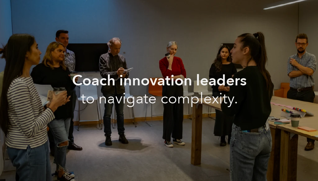 An image of our 'care lab' workshop, with Director Lara Dolz speaking to a series of leaders in the non-profit industry. the text 'coach innovation leaders to navigate complaxity' is inlayed