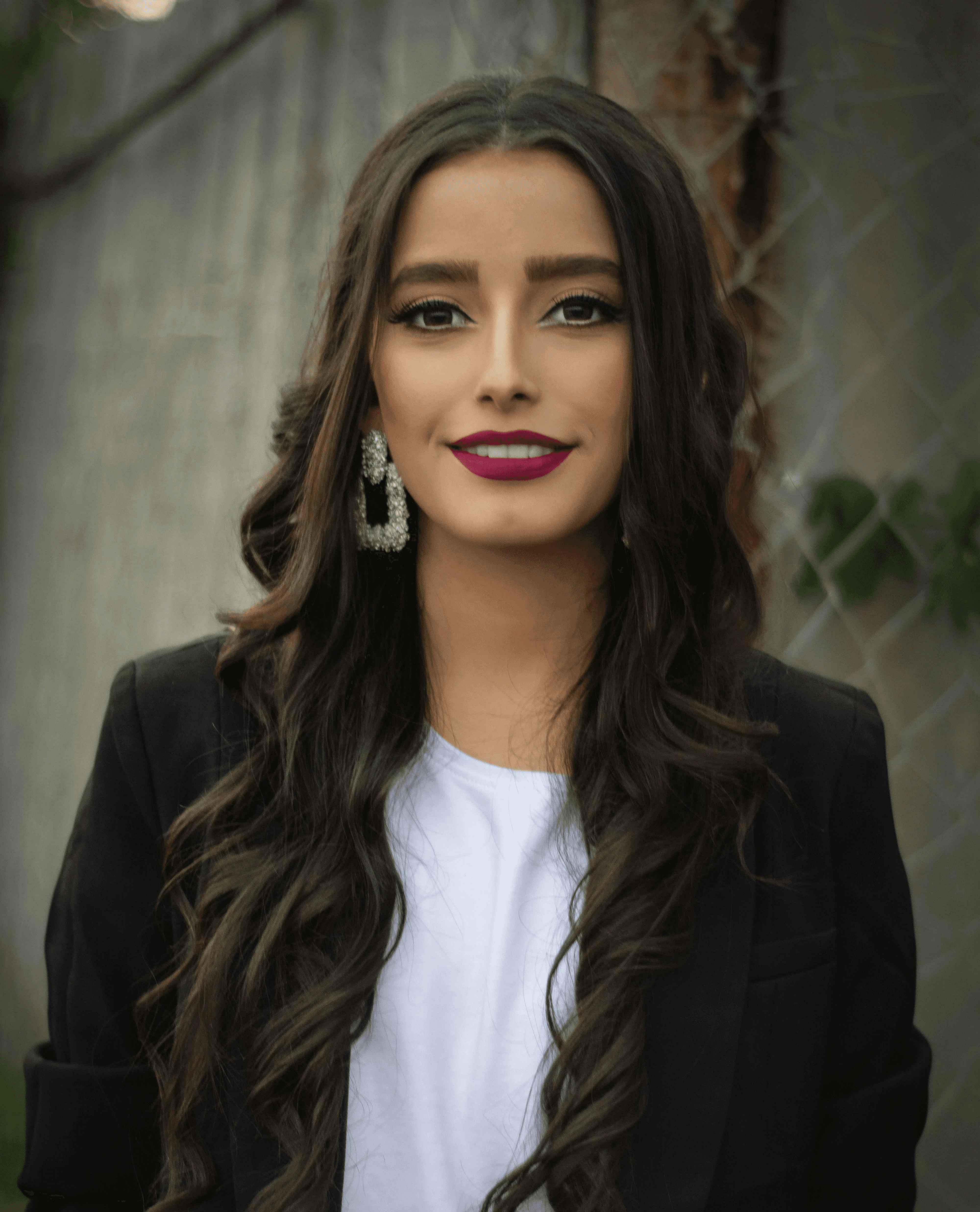 woman in black blazer smiling
