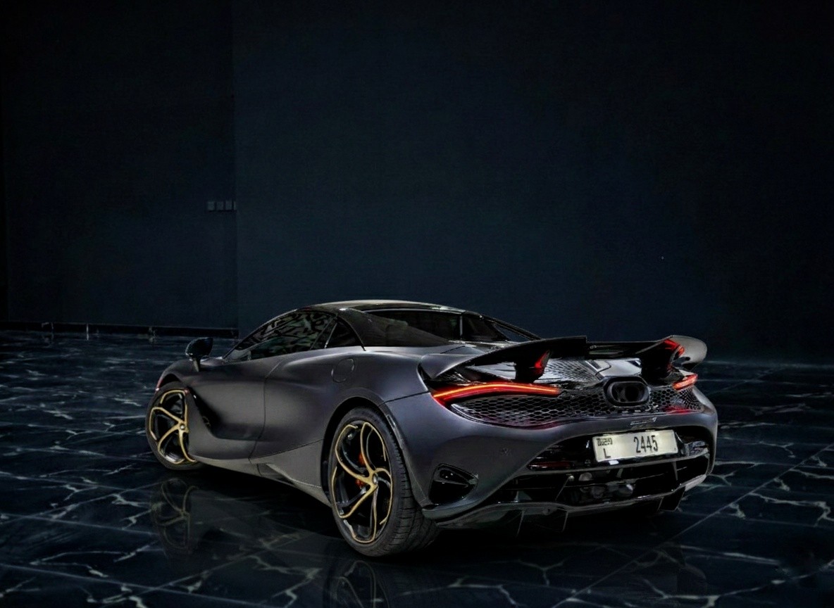 Rear view of McLaren 750S Spider showcasing open-top design and performance styling at Queen of Supercar Rental.