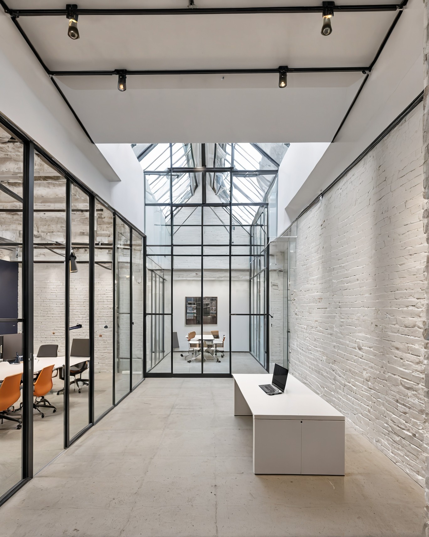 Open-concept modern office with industrial ceiling, suspended lights, and exposed ducting—designed for collaborative flow