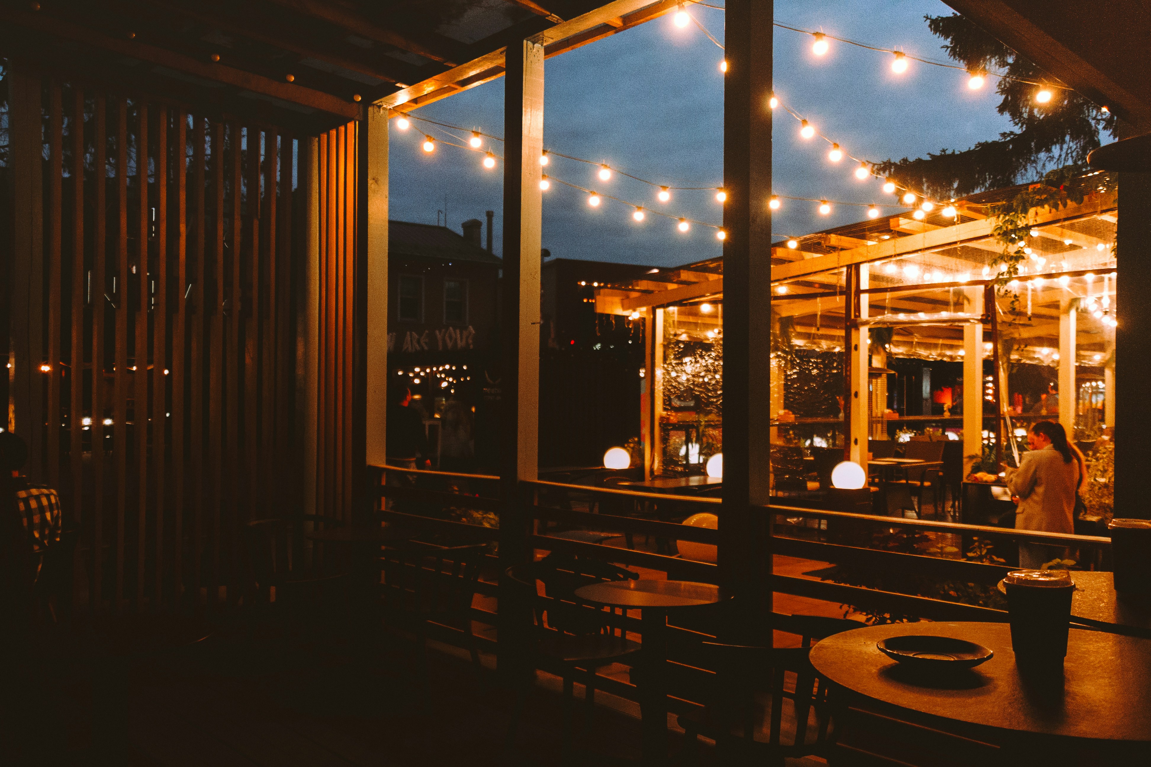 Outdoor cafe with string lights at dusk