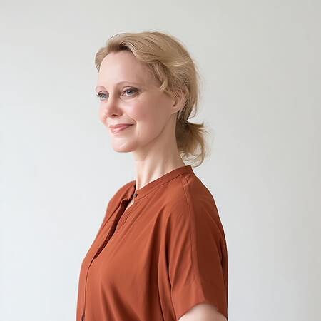 Woman in terracotta blouse presenting discovery call thank-you message AI prompt for menopause coaches