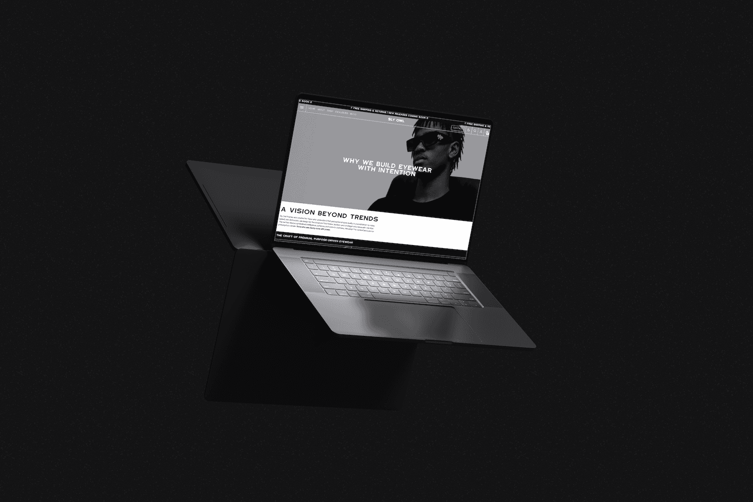 a floating laptop in a dark studio setting showcasing a website with a man wearing sunglasses