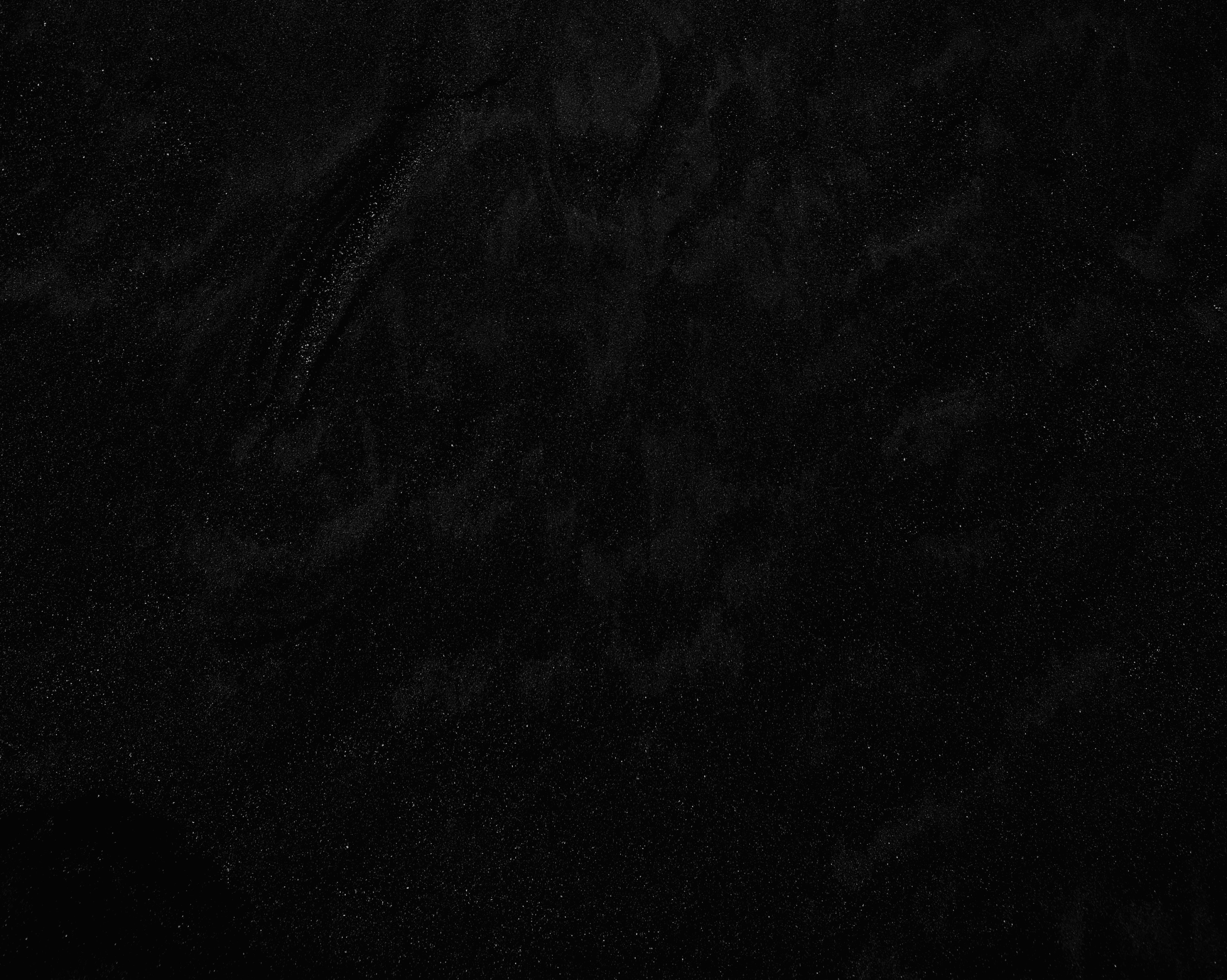 a black and white photo of water and sand