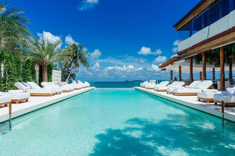 sunloungers fronting buildings near mountain