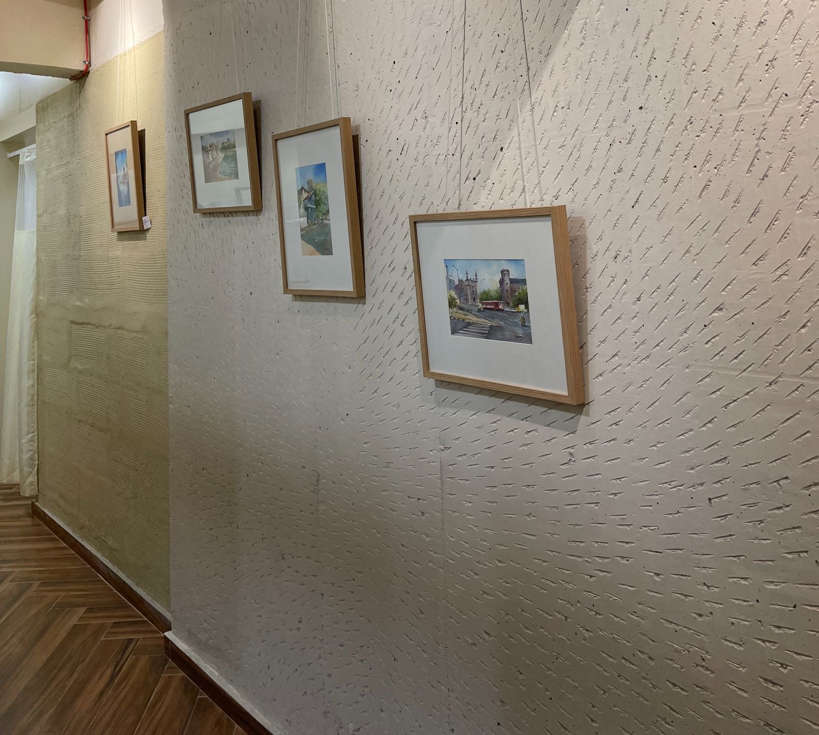 Nature-inspired preschool entrance with sculptural tree partitions and suspended green leaf ceiling panels.