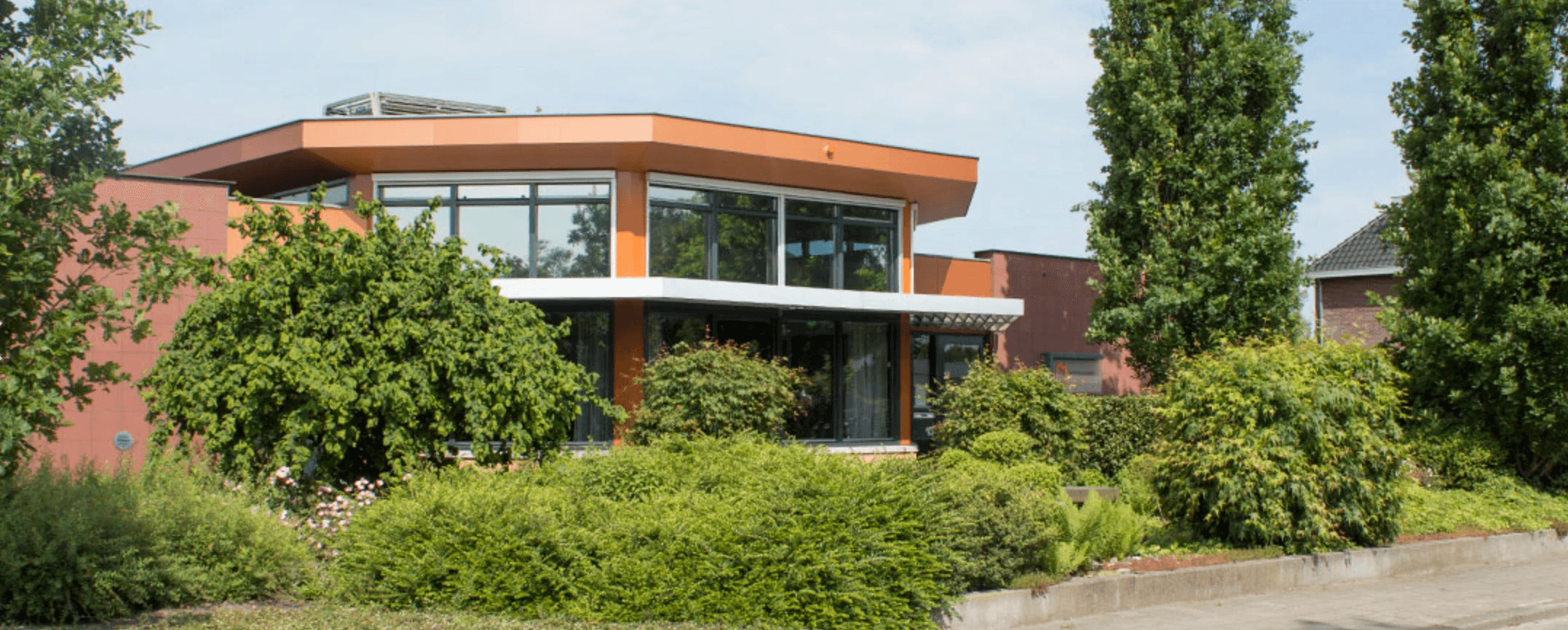 Modern kitchen interior featuring a central island, wooden cabinetry, and bright lighting. Spacious and minimalist design.
