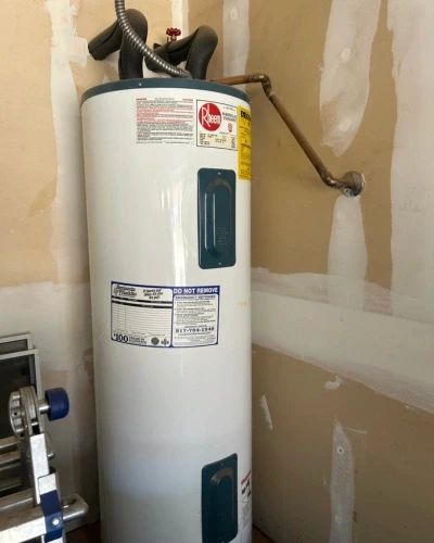 Licensed plumber repairing a residential water heater in Arlington, TX