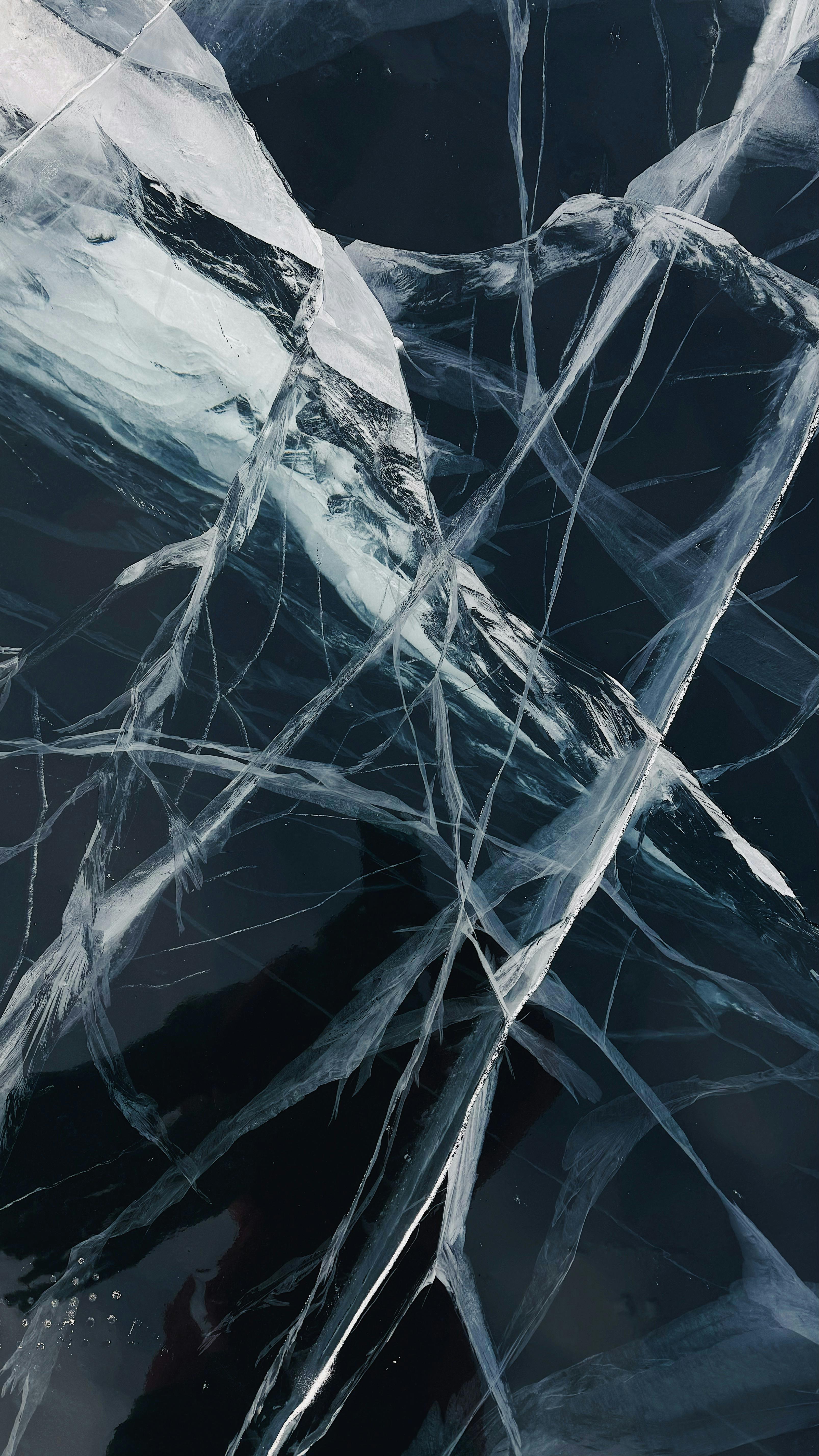 Cracked ice with a dark background and thin cracks.