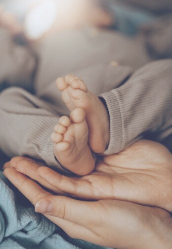baby feet in parent's hands
