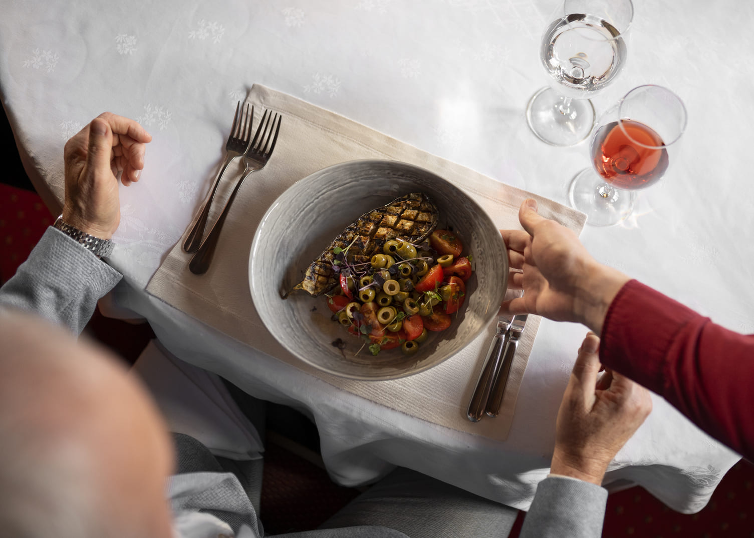 a plate of food on a table with a fork and knife