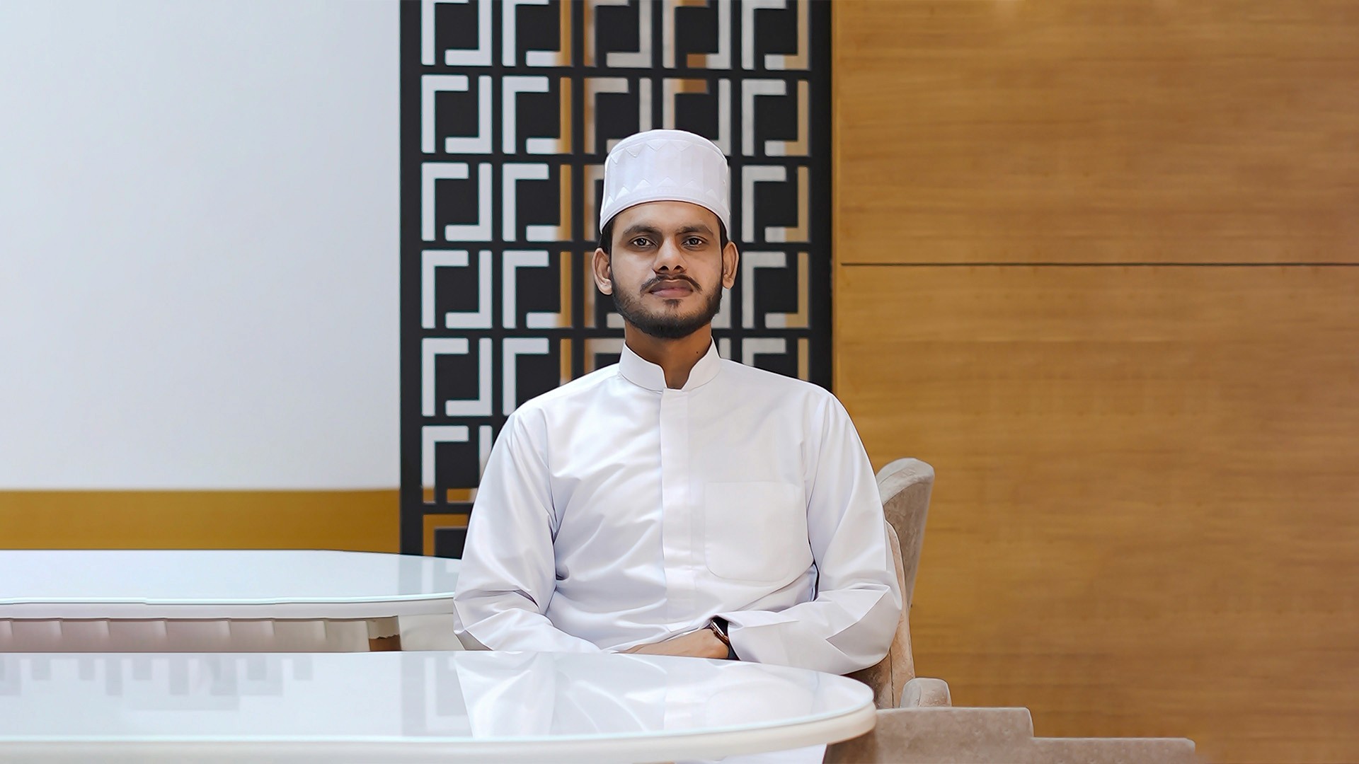 man in black suit jacket holding white ceramic mug