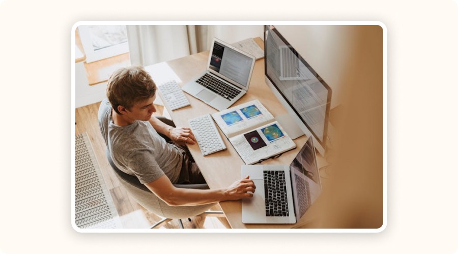 Person on laptops tracking Shopify competitors.