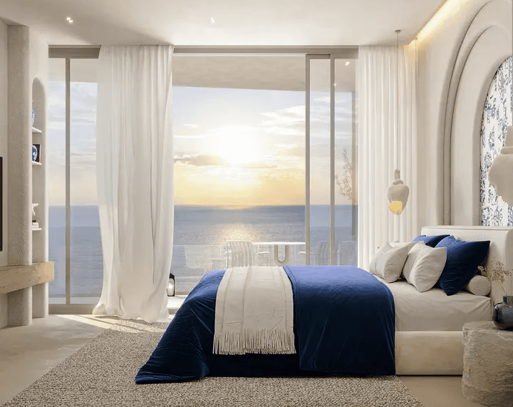 A pool with lounge chairs and umbrellas next to a house