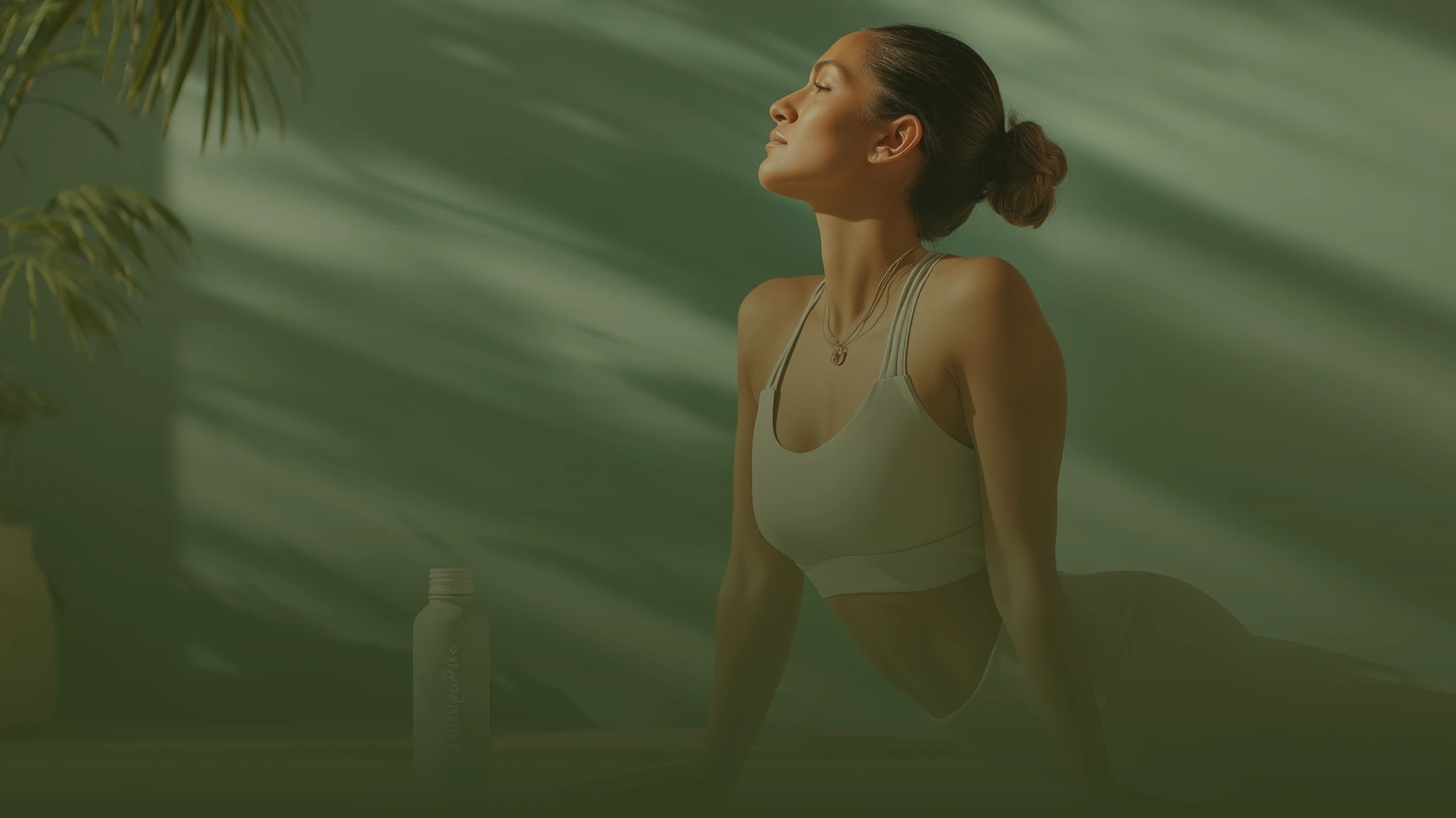 Woman practicing yoga cobra pose outdoors in a calm wellness setting with natural light